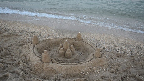 Sandcastle with walls at the beach.