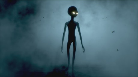 Scary gey Alien with glowing eyes walks with a light shining behind.