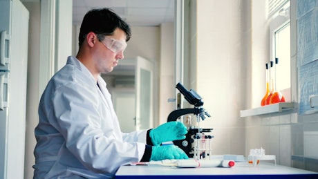 Scientist in a laboratory preparing a sample.