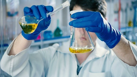 Scientist mixing liquids in a laboratory