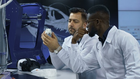 Scientists with 3D printing object
