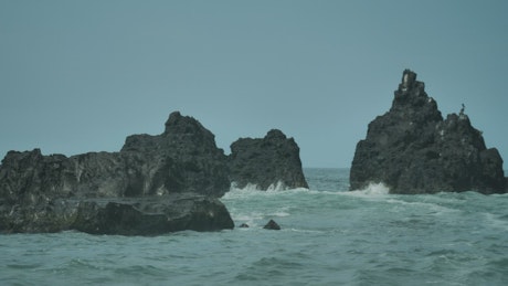Sea waves and big rocks.