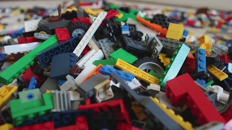 Selecting pieces of lego in a pile.