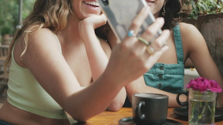 Selfie between two friends in a coffee shop.
