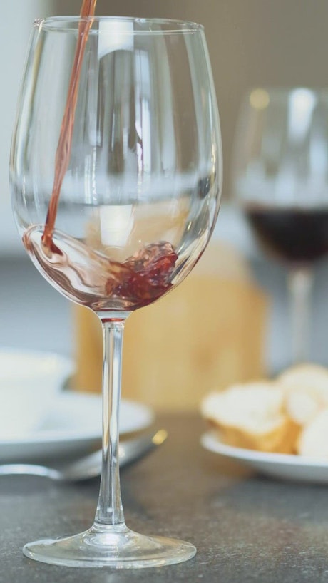 Serving wine in a glass viewed in detail.