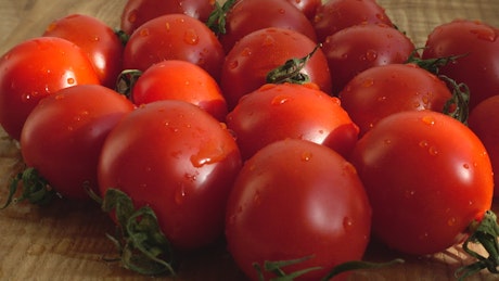 Set of wet tomatoes spinning in a close up shot.