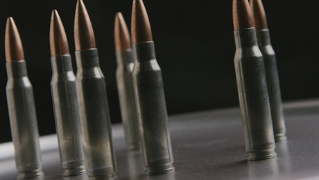 Several bullets rotating on a metal plate.