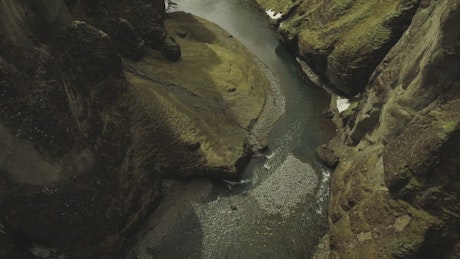 Shallow river flowing through a canyon.