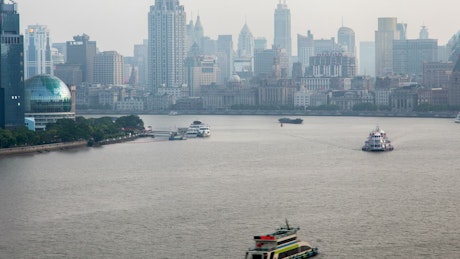 Shanghai river traffic and the city buildings.