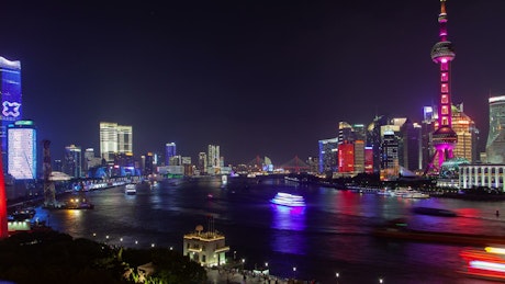 Shanghai river with illuminated city buildings.