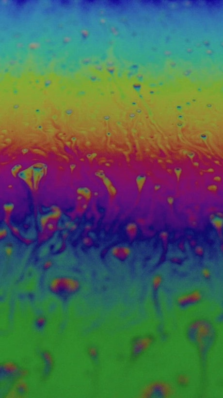 Shapes and iridescent colors of a soap bubble.