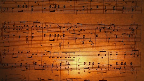 Sheet music burning with a candle