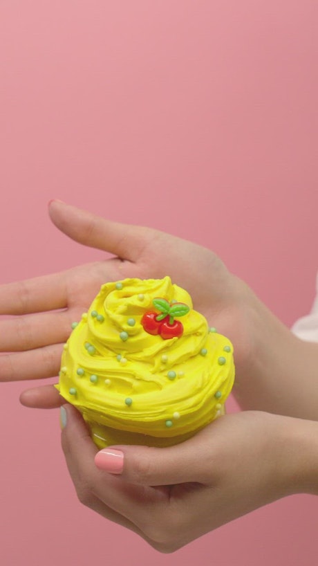 Showing yellow plasticine in the shape of ice cream.