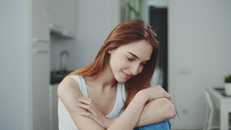 Shy smiling woman in blue jeans