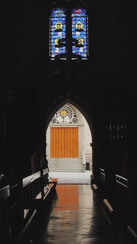 Side door of a gothic church in the dark.