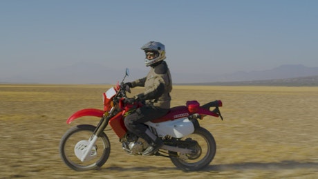 Side shot of a biker in the desert