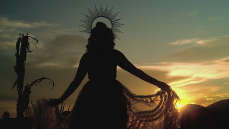 Silhouette of a catrina at sunset.