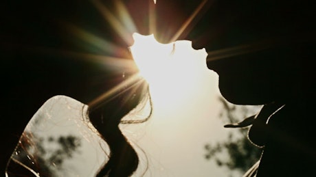 Silhouette of a kissing couple.
