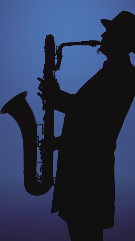 Silhouette of a musician playing the saxophone.