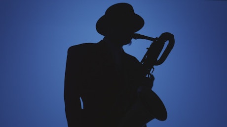 Silhouette of a saxophonist playing on a blue background.