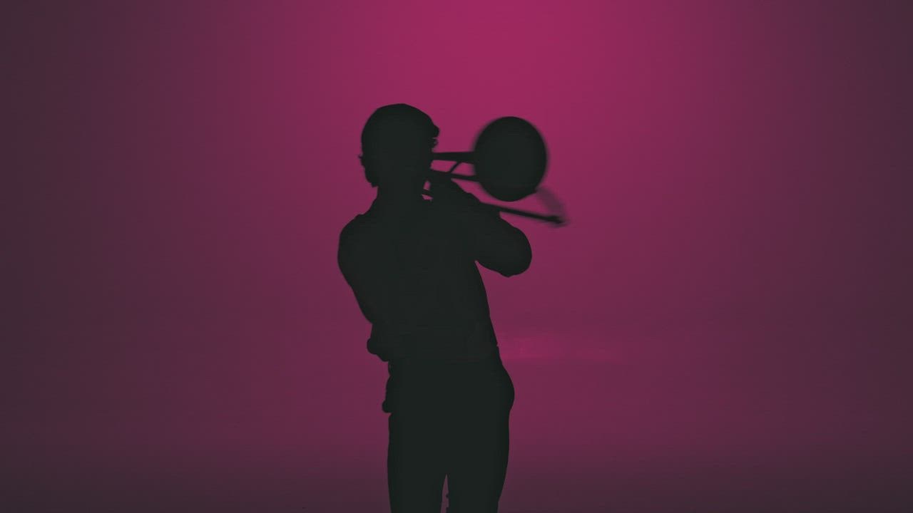 Silhouette of a trumpet player playing with passion - Free Stock Video
