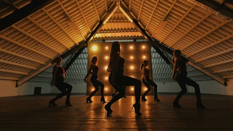 Silhouette of dancers performing a choreography.