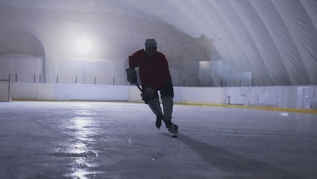 Silhouette of ice hockey player during training.