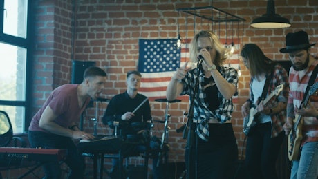 Singer giving instructions to band on a rehearsal