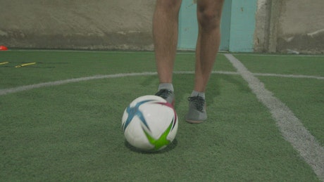Skilled soccer player doing tricks with the ball