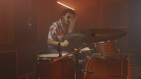 Skillfully drummer playing in a recording studio