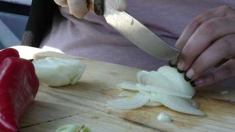 Slicing an onion on a board