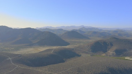 Slow overflight of a mountain range in an arid climate.
