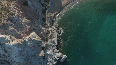 Small beach on a cliff, aerial top shot.