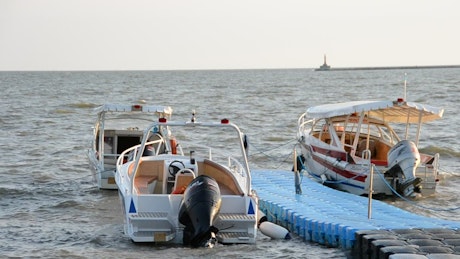 Small boats docked on a beach ramp