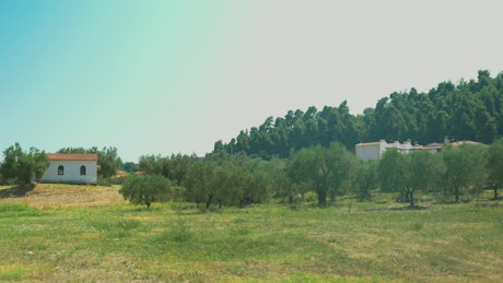 Small rural buildings in a field.