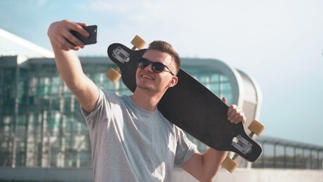 Smiling skater takes selfie for social media
