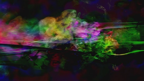 Smoke fluids of many colors on black background.