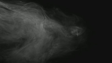 Smoke shapes floating in the dark