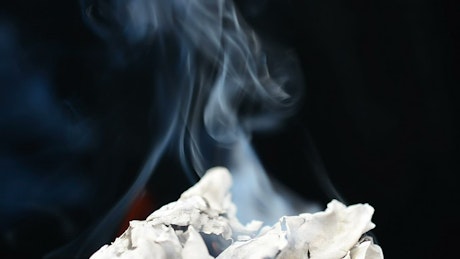 Smoking paper burning slowly.