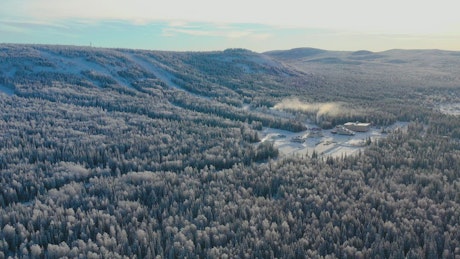 Snow covered mountain forest and Ski Resort