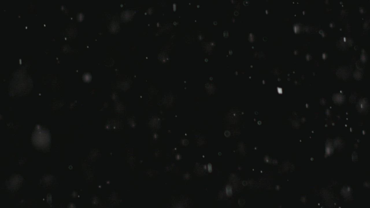 Snow falling in a black background - Free Stock Video