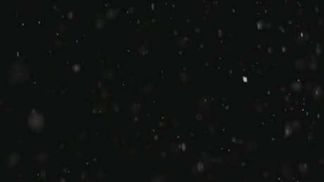 Snow falling in a black background.