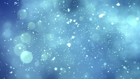 Snowing snowflakes on blue background.
