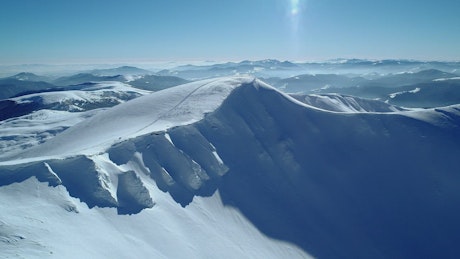 Snowy hill in a mountain range