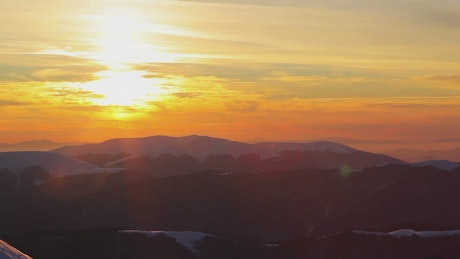 Snowy mountains landscape during sunset, pan shot