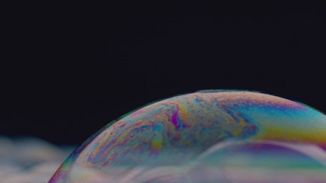Soap bubble surfaces with iridescent effect.