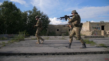 Soldiers clearing an urban ruin.