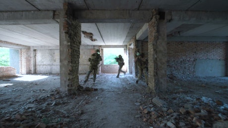 Soldiers entering an abandoned building.