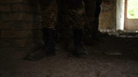 Soldiers walking through dust