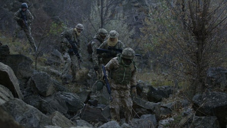 Soldiers walking through the rocks